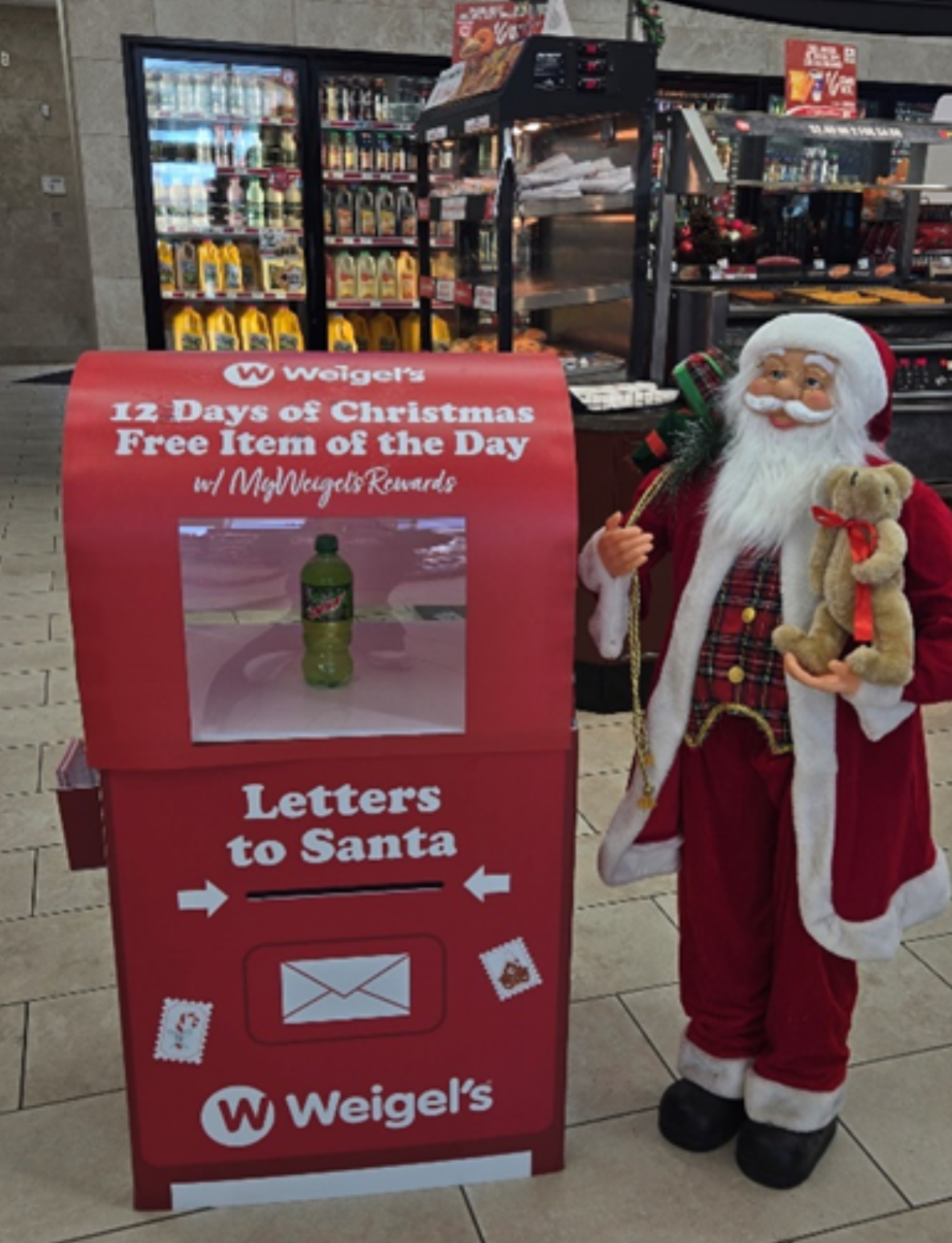 Festive display at Weigel's featuring a Letters to Santa mailbox alongside the 12 Days of Christmas promotion. Customers can see the daily free item showcased, spreading holiday cheer with MyWeigel's Rewards!